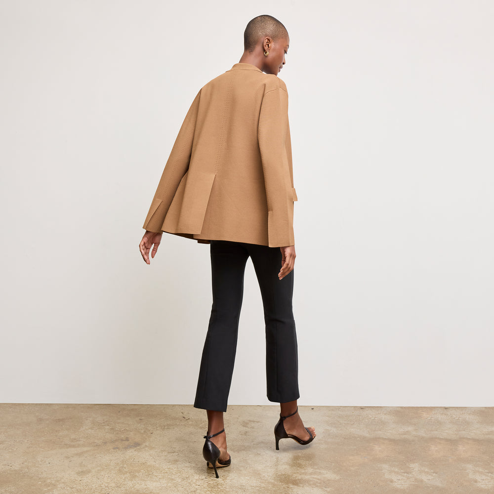 back image of a woman wearing the cody jardigan in saddle