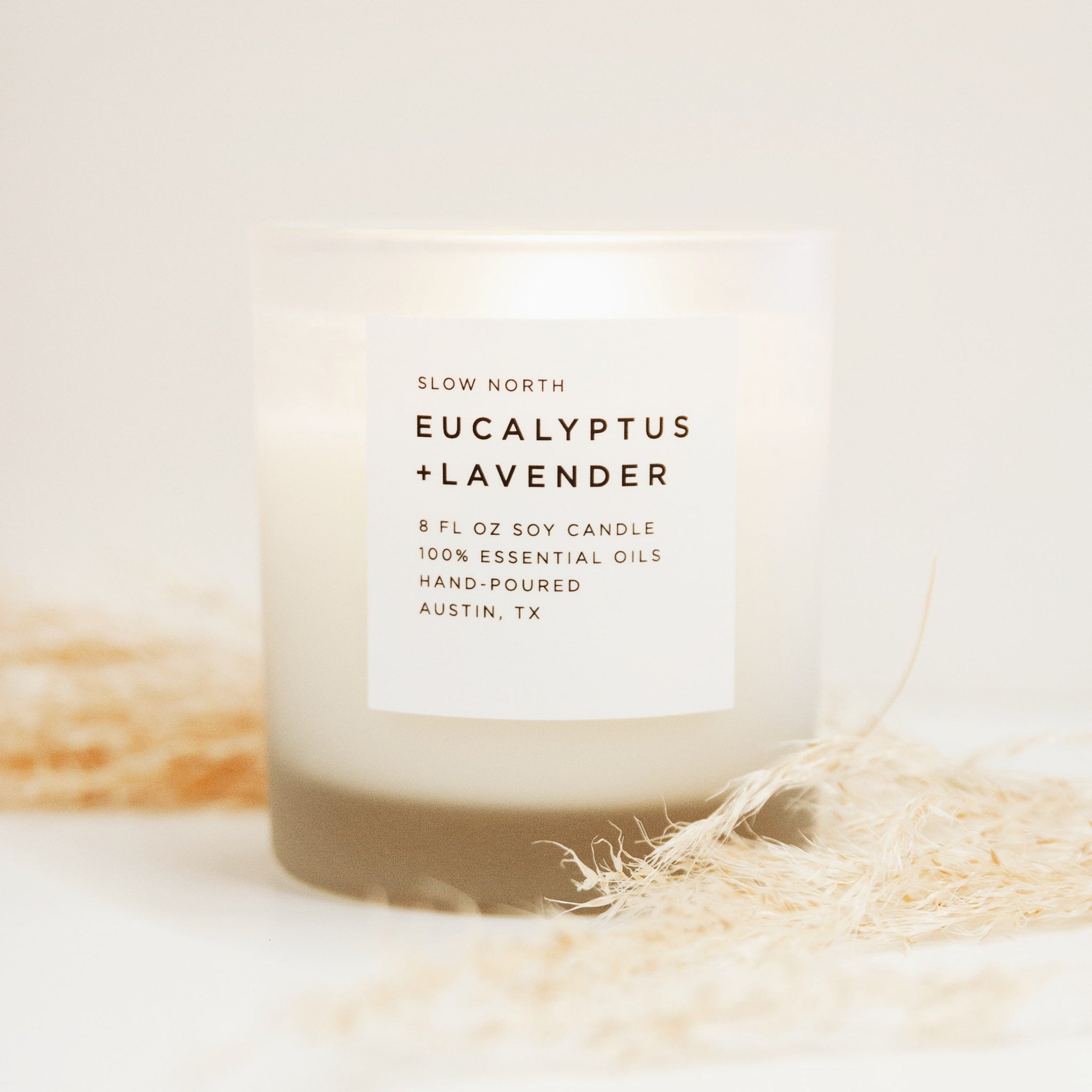 Candle labeled 'Eucalyptus + Lavender' by Slow North on a light background
