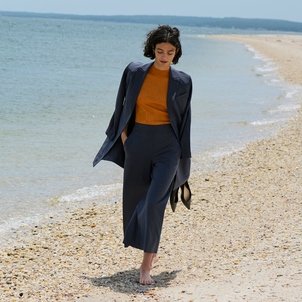 front image of a woman wearing the elena pant in cool charcoal
