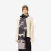 Image of a woman wearing a scarf with animals on it in black white and gray