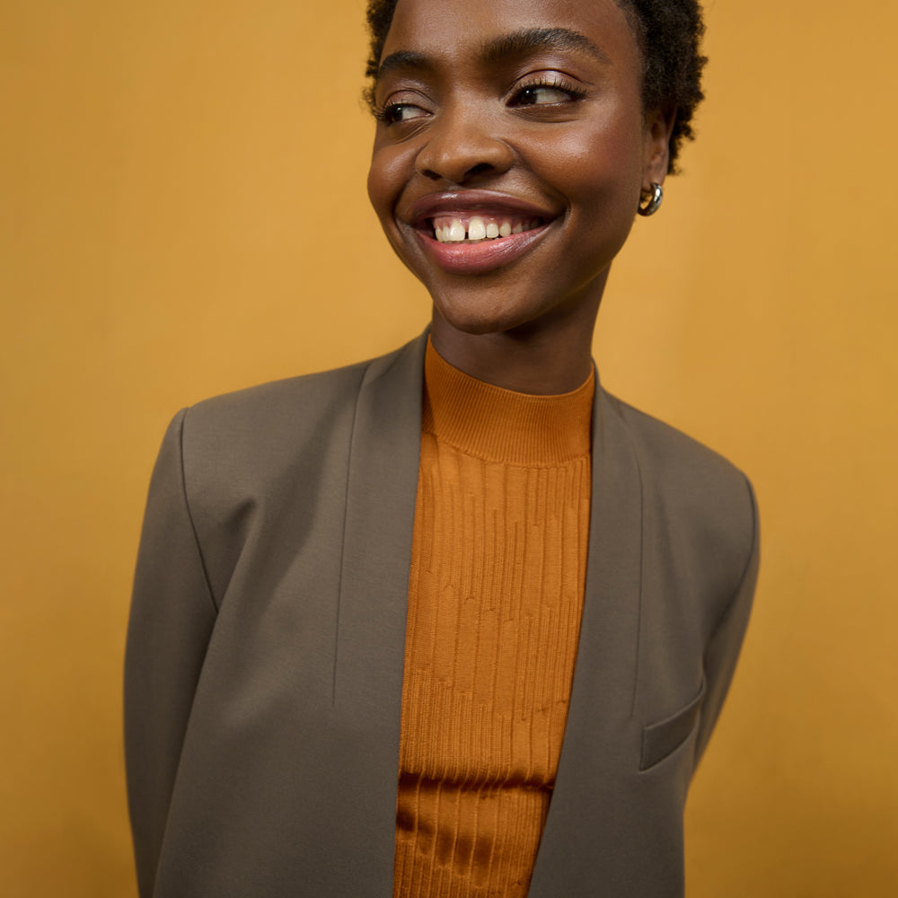 front image of a woman wearing the janette jacket in ash