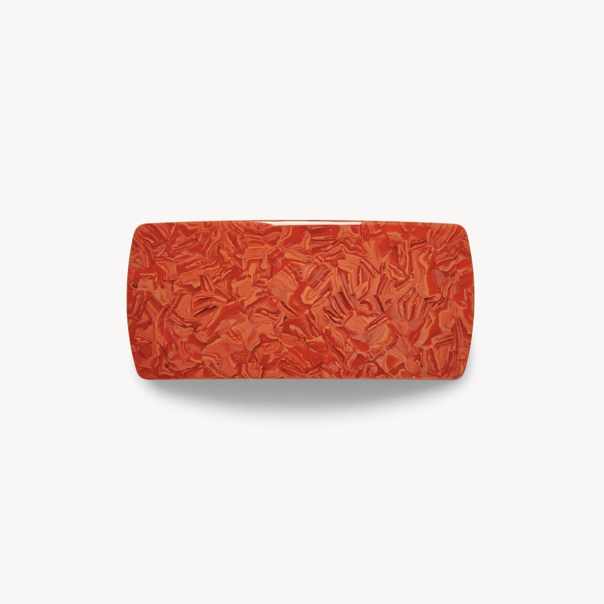 Red textured hair clip on a white background 