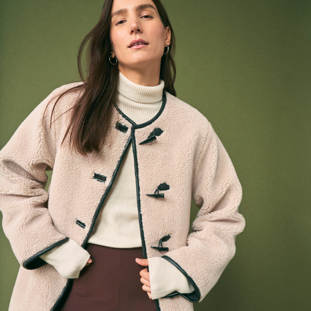 front image of a woman wearing the katari jacket in travertine