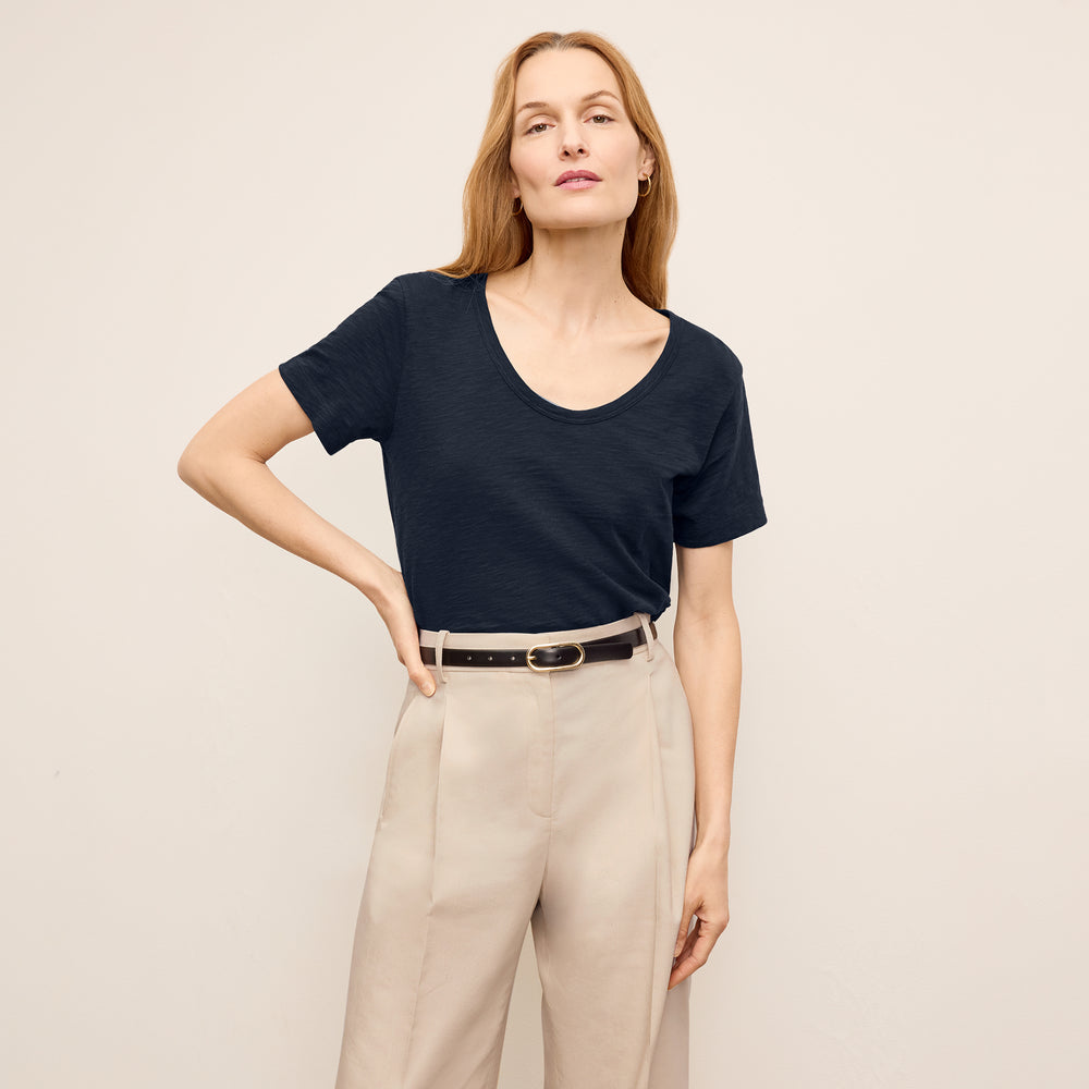front image of a woman wearing the kenya shirt in dark navy