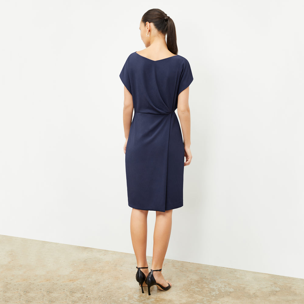 back image of a woman wearing the jillian dress in caspian blue