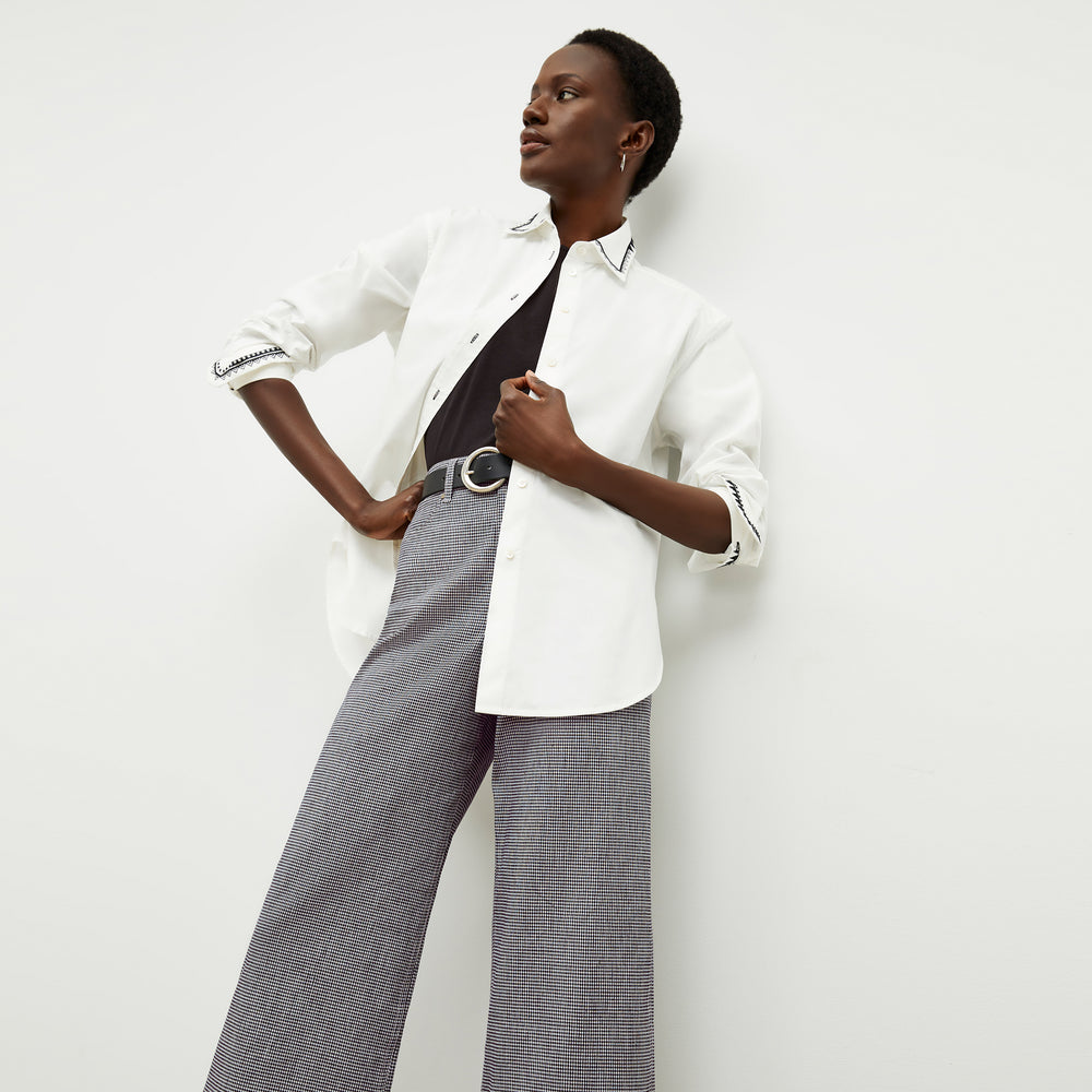 front image of a woman wearing the mila button down in white