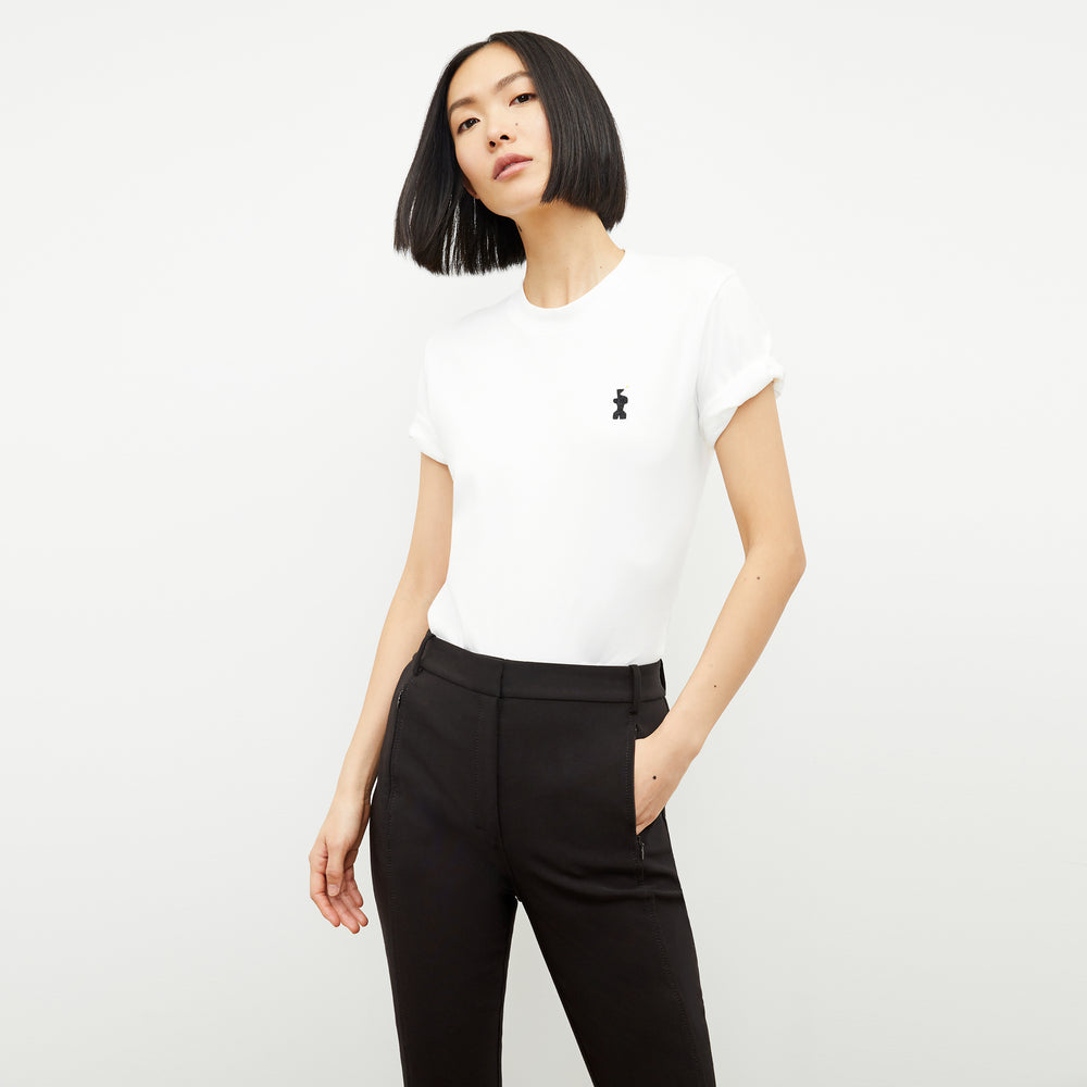 front image of a woman wearing the leslie t-shirt embroidered in white