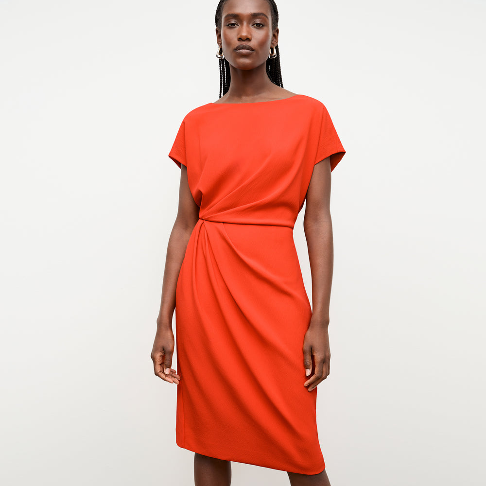 front image of a woman wearing the jillian dress in bright coral