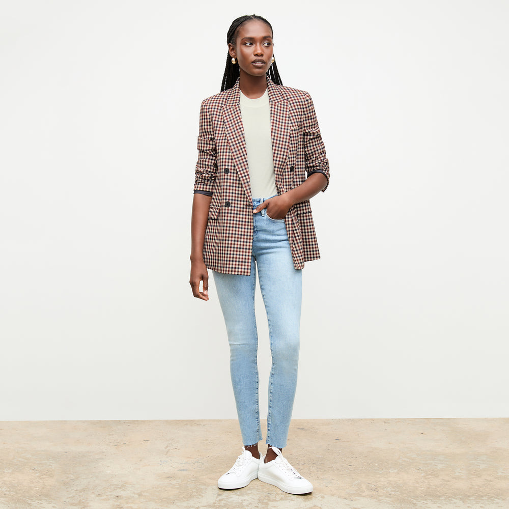 front image of a woman wearing the frame denim le high skinny raw after jean in galeston