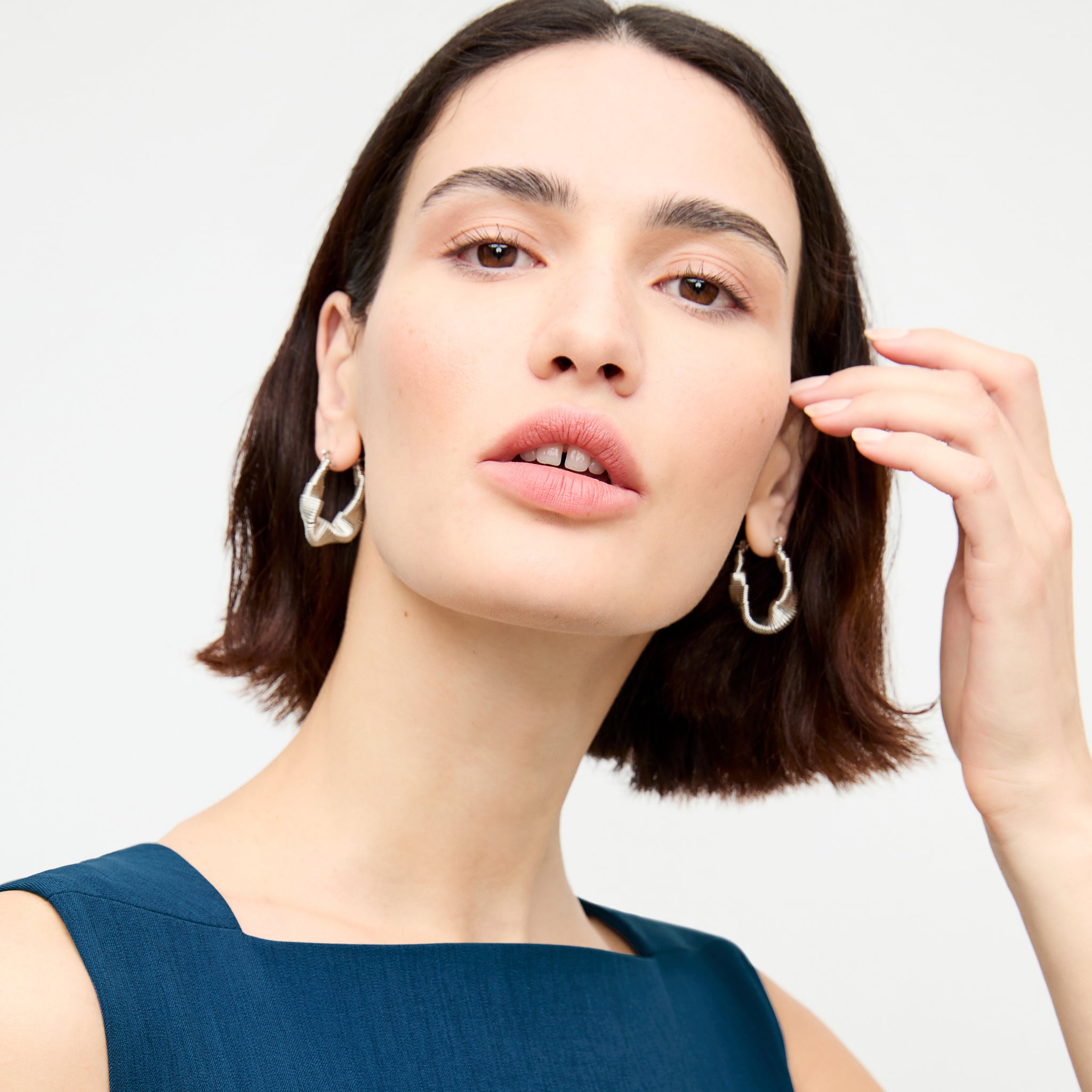 front image of a woman wearing the amy earrings in silver