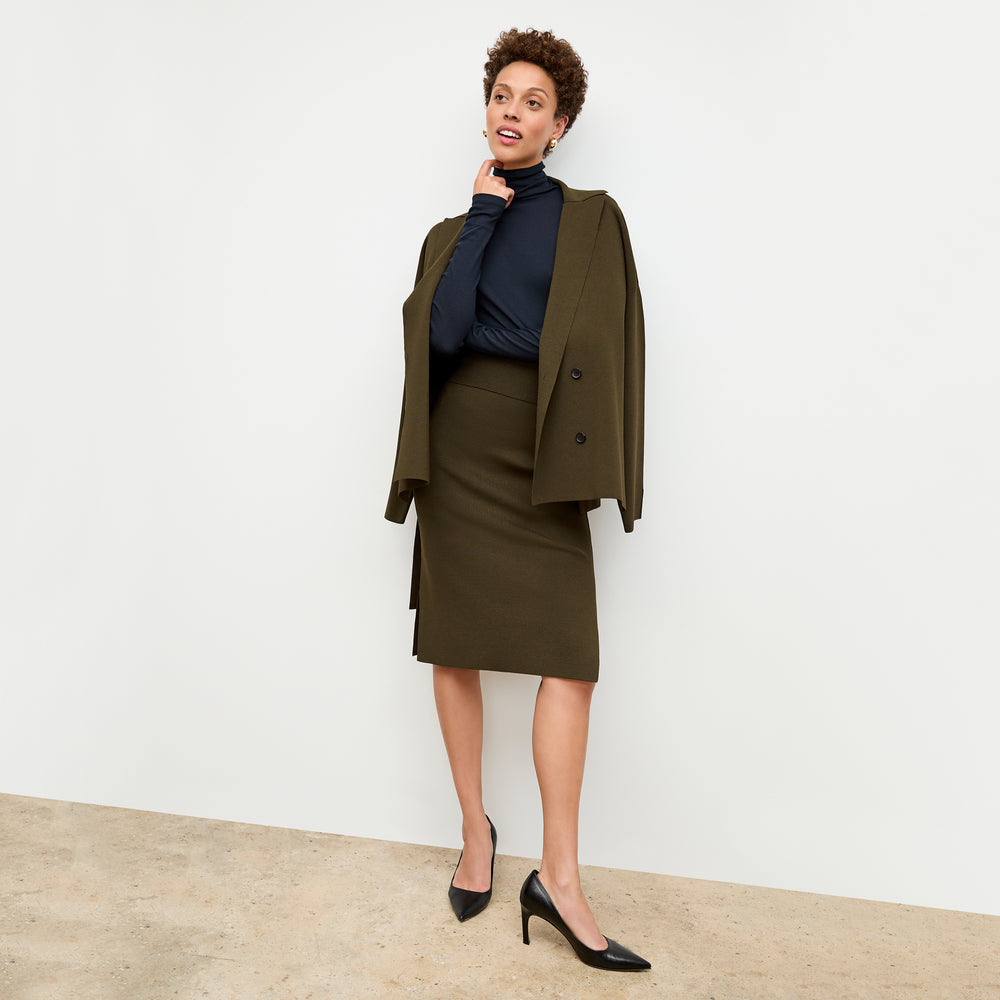 front image of a woman wearing the harlem skirt in dark elm