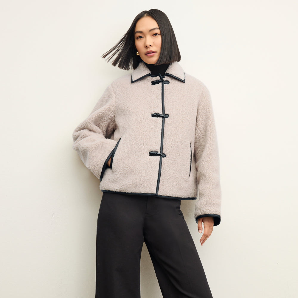 Front image of a woman wearing the eli jacket in travertine