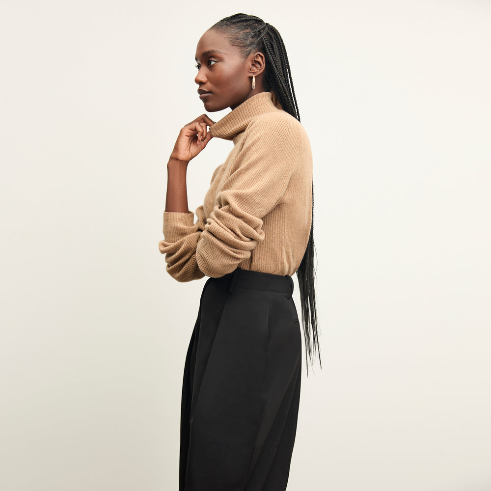 front image of a woman wearing the mckenzie sweater in deep flax