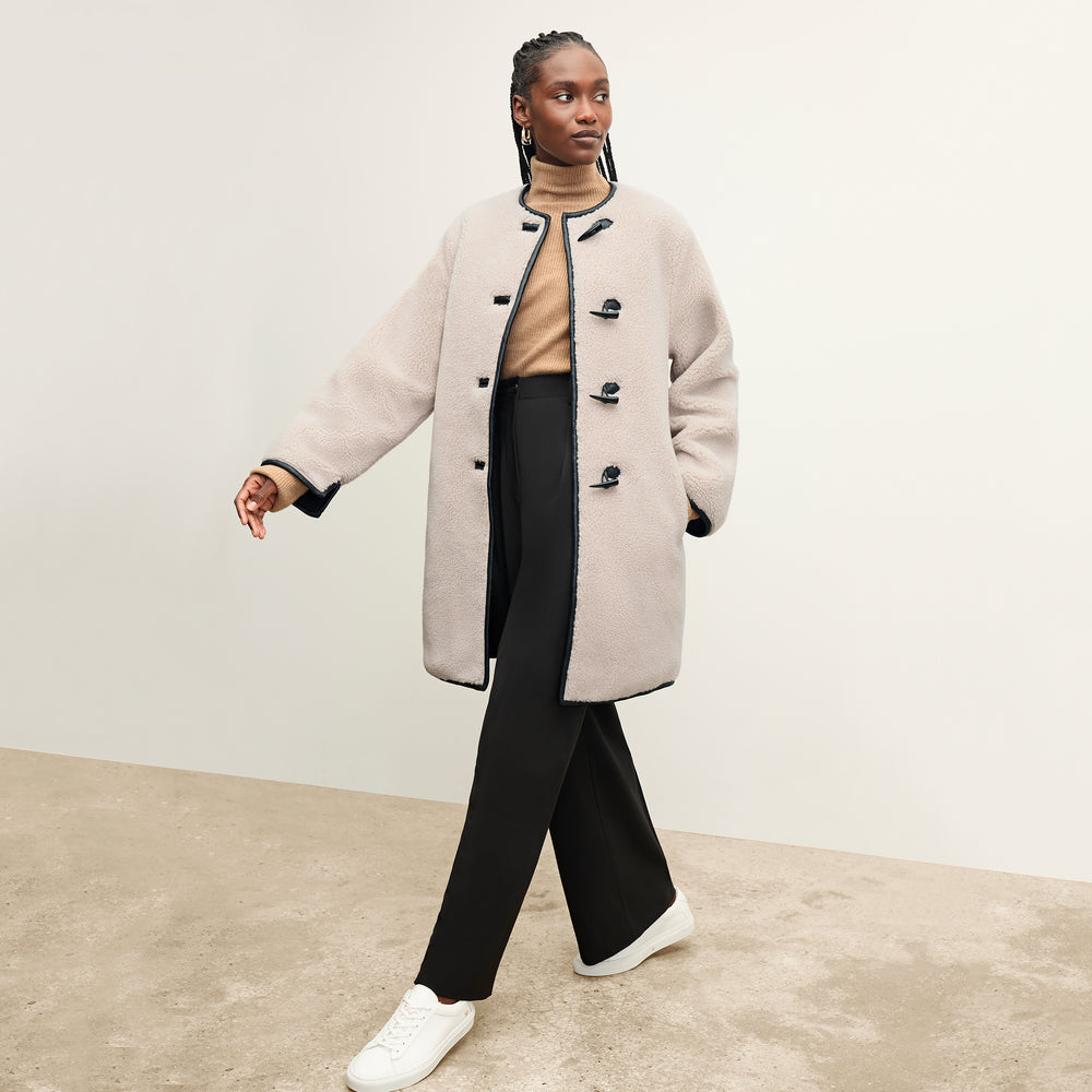 front image of a woman wearing the katari jacket in travertine