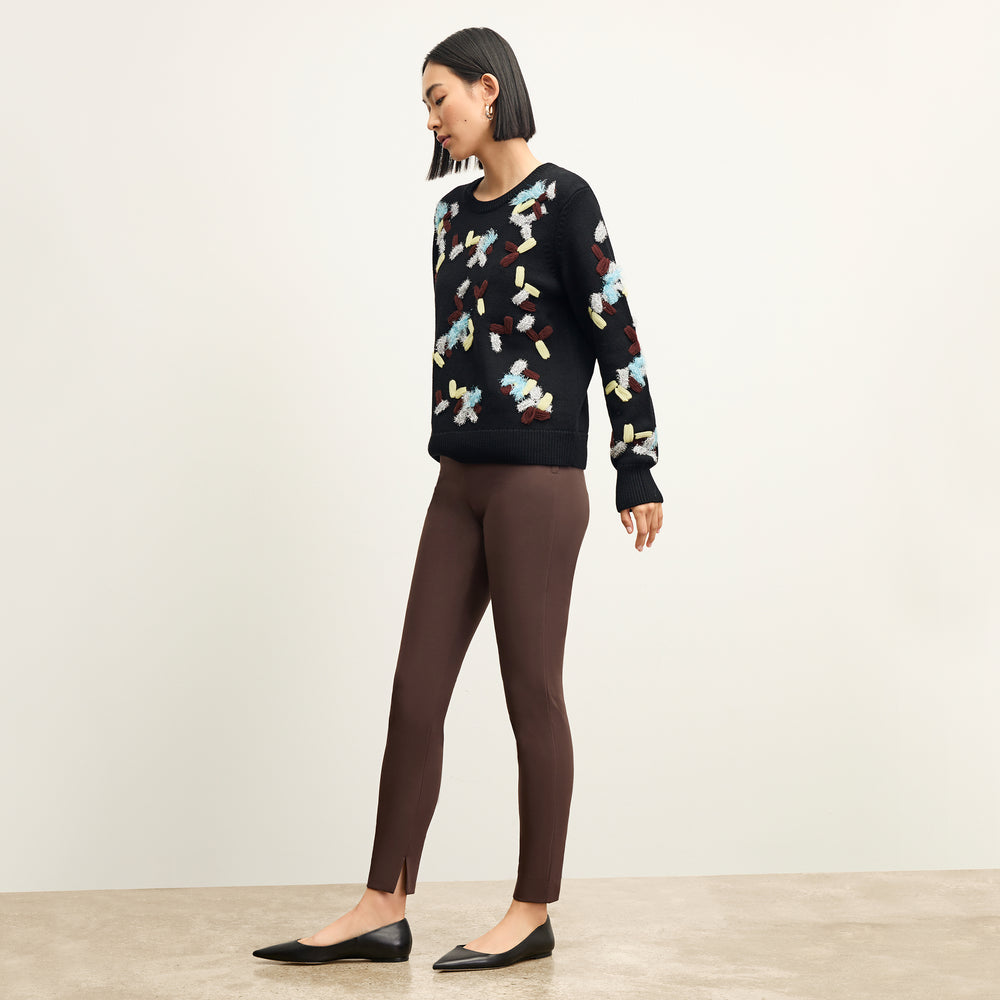 side image of a woman wearing the tish sweater in confetti