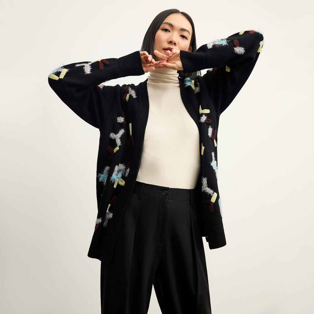 front image of a woman wearing the cookie cardigan in confetti