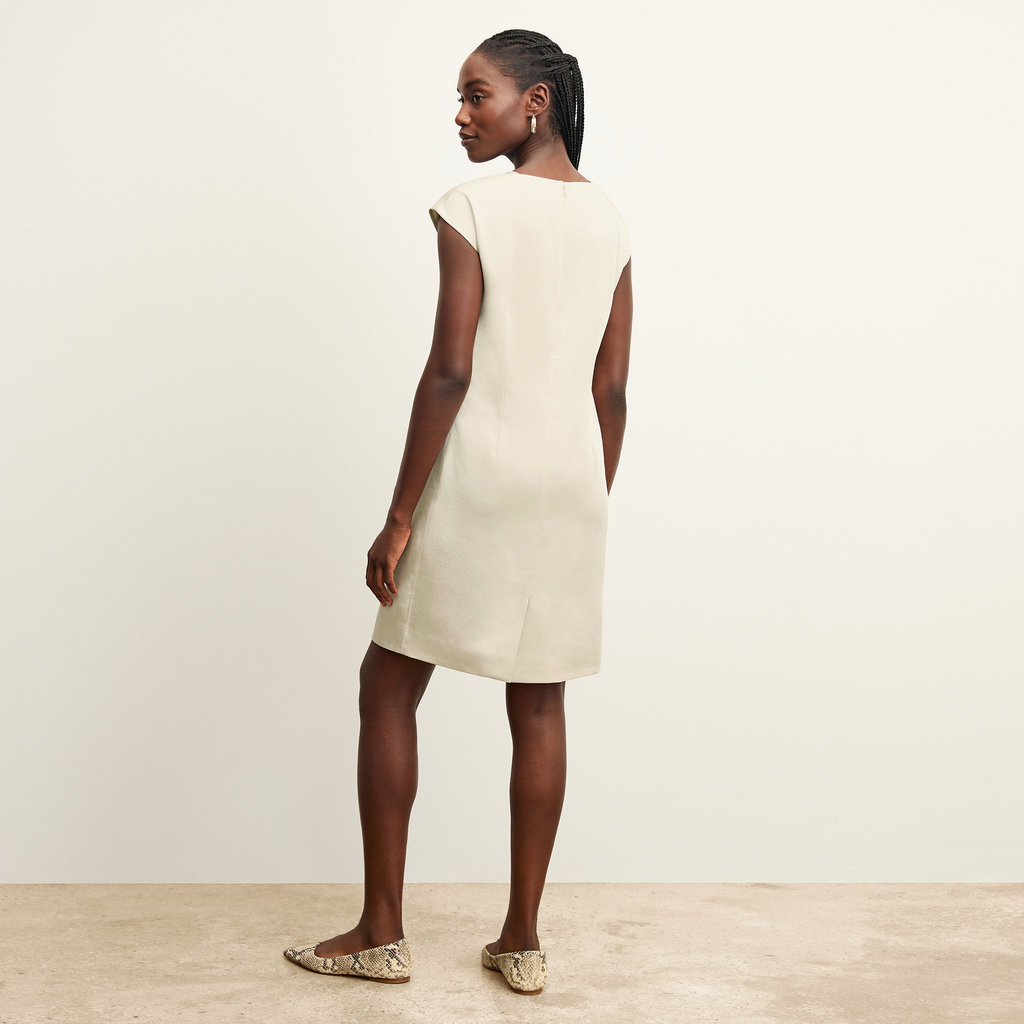 back image of a woman wearing the maaza dress in champagne