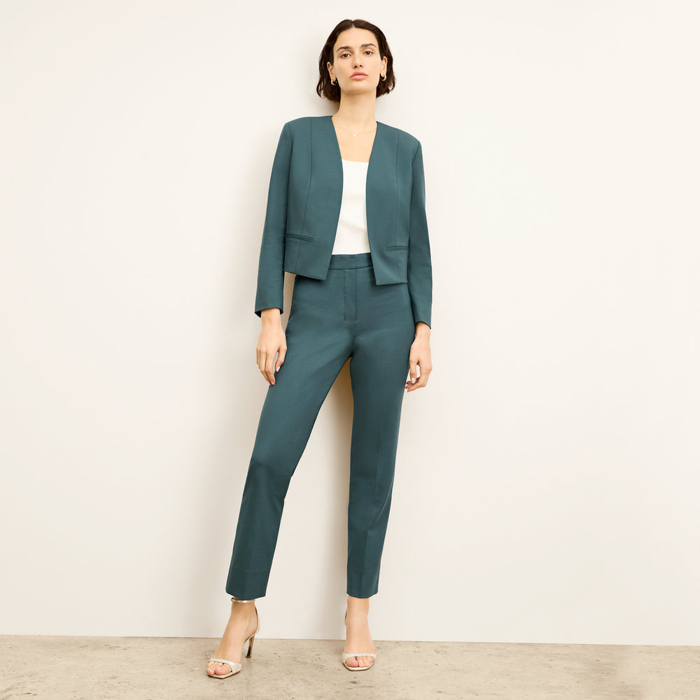 front image of a woman wearing the neale jacket in blue jade