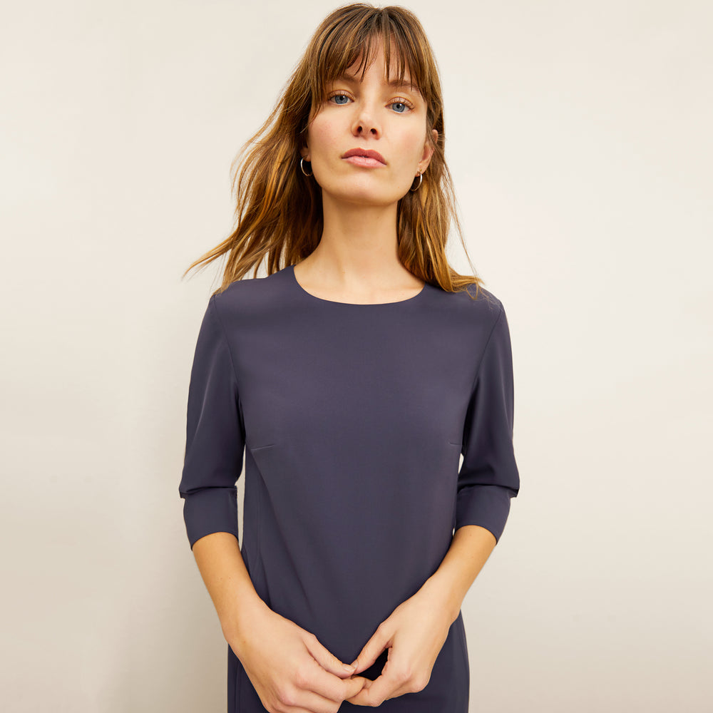 front image of a woman wearing the lancia dress in cool charcoal