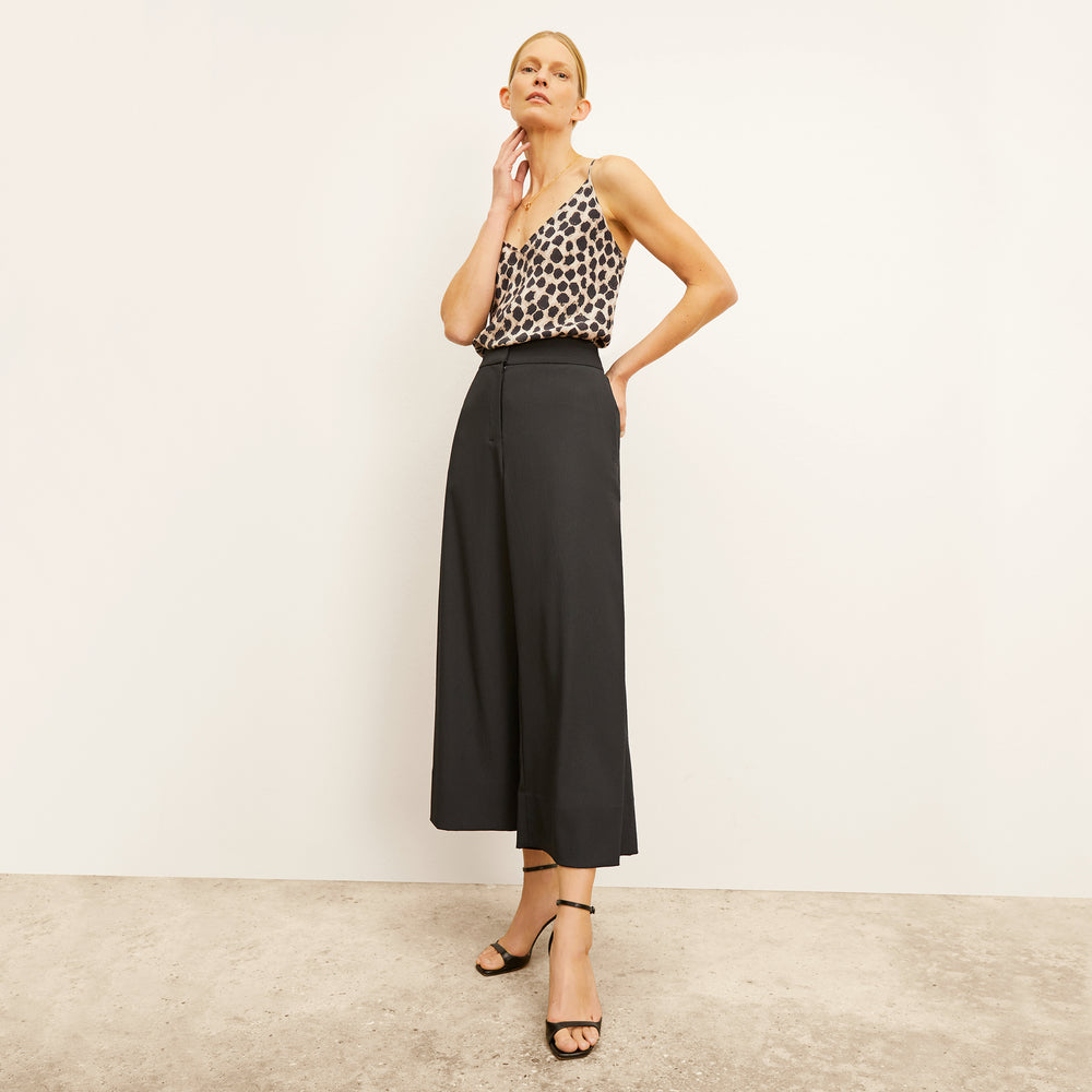 Front image of a woman standing wearing the Lisey Cami—Sahara Print Washable Silk in Tan/Black
