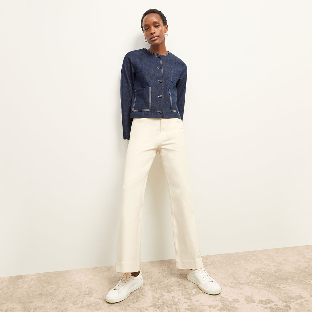 front image of a woman wearing the kane jacket in dark wash