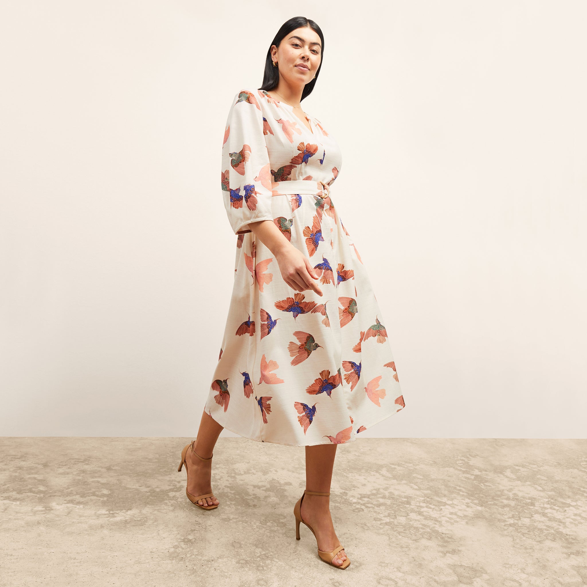 front image of a woman wearing the tessie dress in hummingbird print