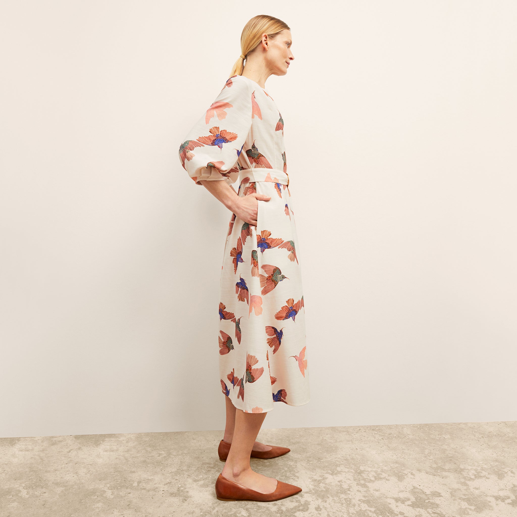 side image of a woman wearing the tessie dress in hummingbird print