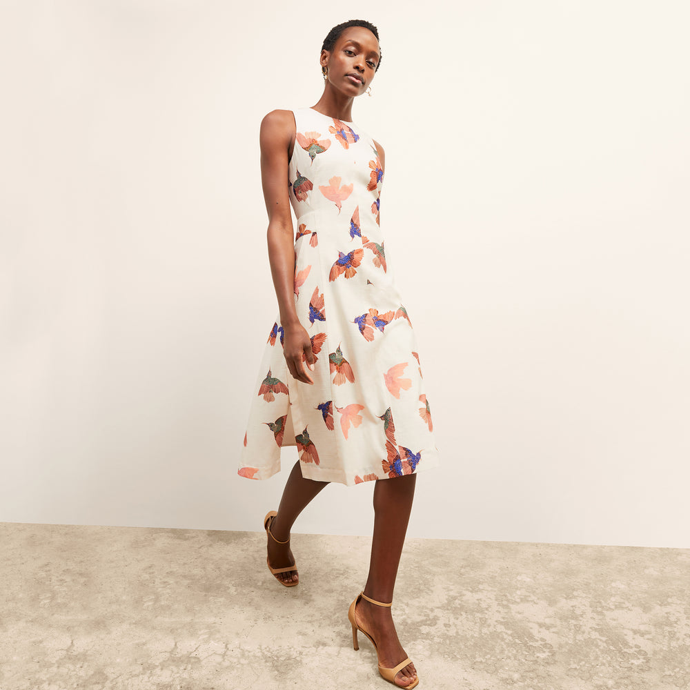 front image of a woman wearing the estela dress in hummingbird print