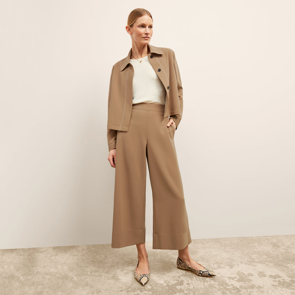 front image of a woman wearing the nicky jacket in saddle