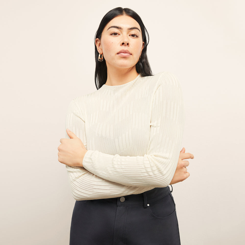 front image of a woman wearing the brodie top in ivory