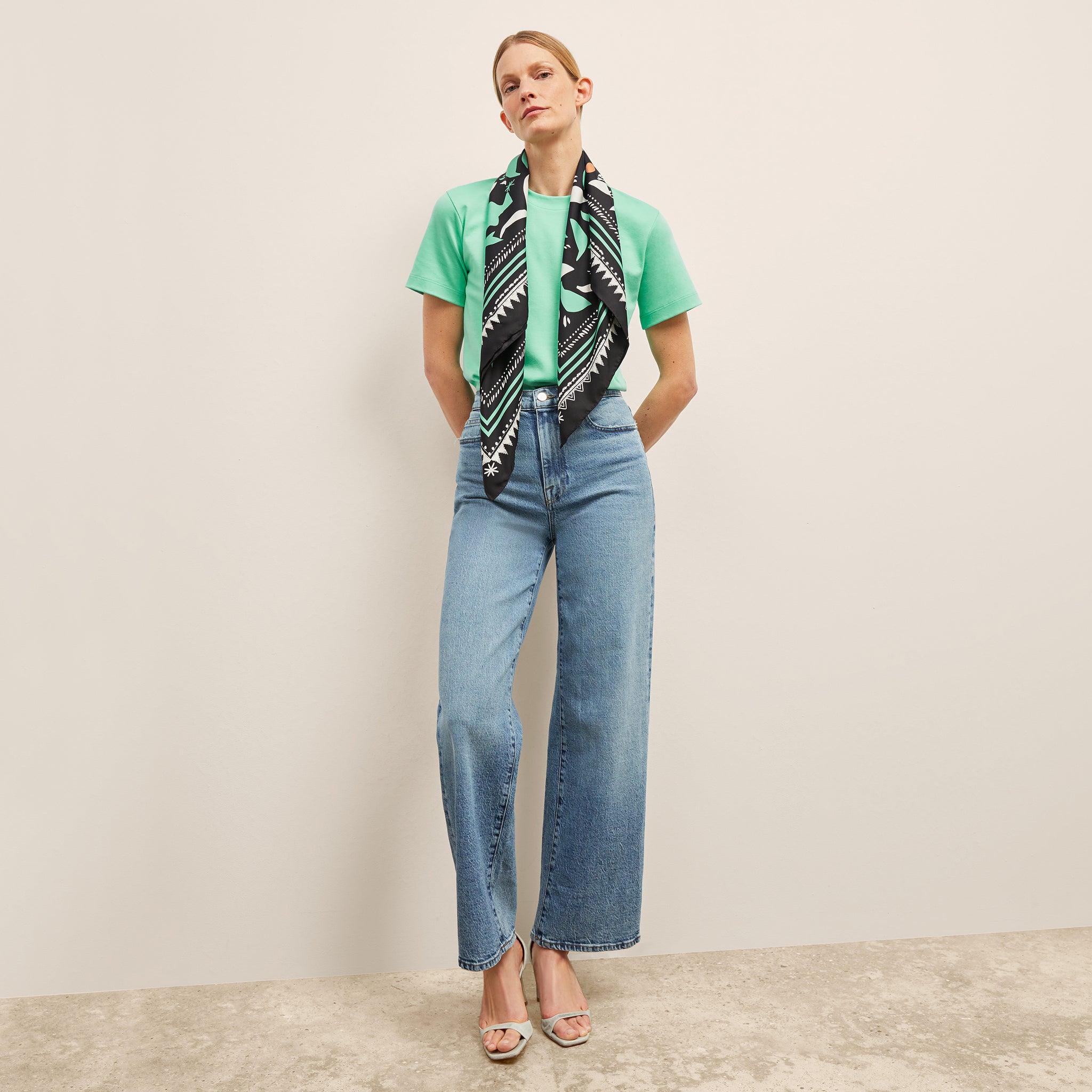 image of a woman wearing the washable silk scarf in seafoam icon print 