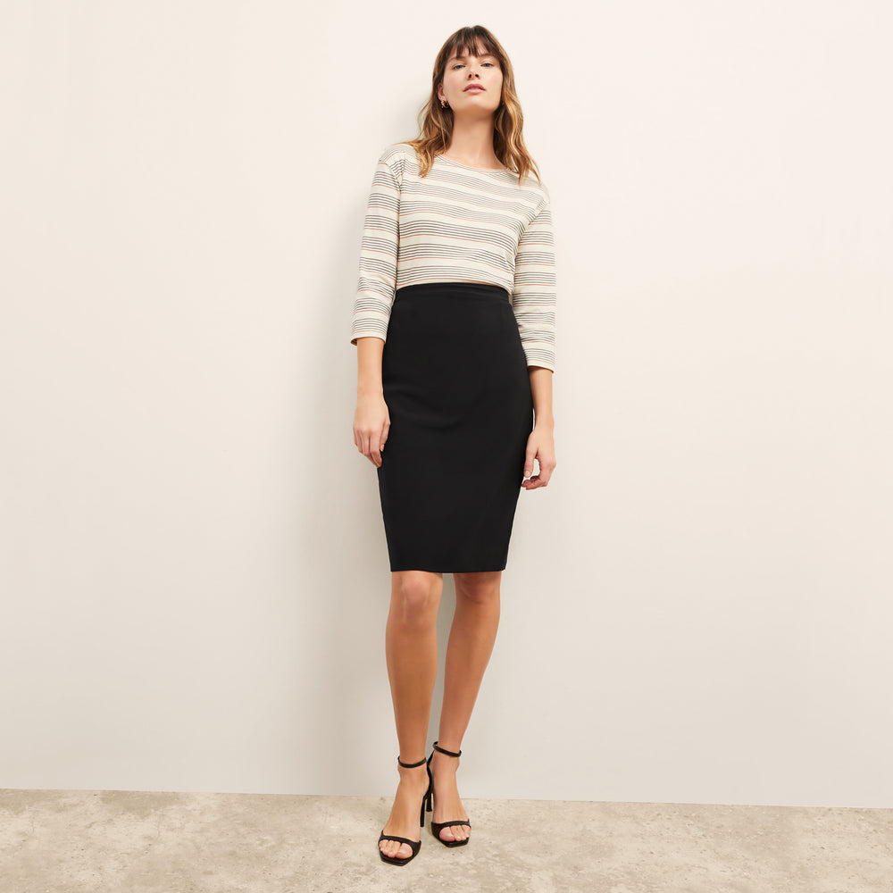 front image of a woman wearing the owen t-shirt in signature stripe