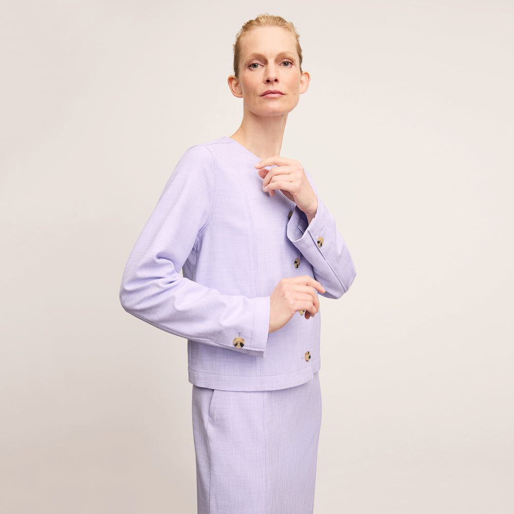 front image of a woman wearing the aniya jacket in lilac/ivory