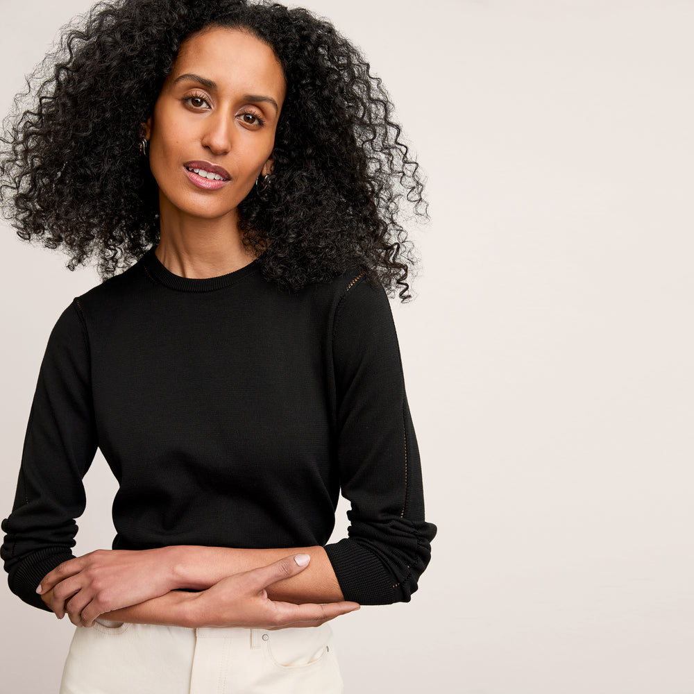 front image of a woman wearing the larissa sweater in black