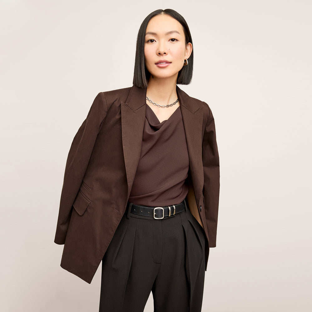 Front image of a woman wearing the Tyner jacket in stretch chino in date