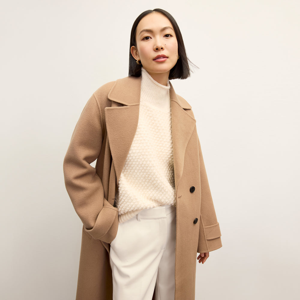 front image of a woman wearing the lea sweater in snow