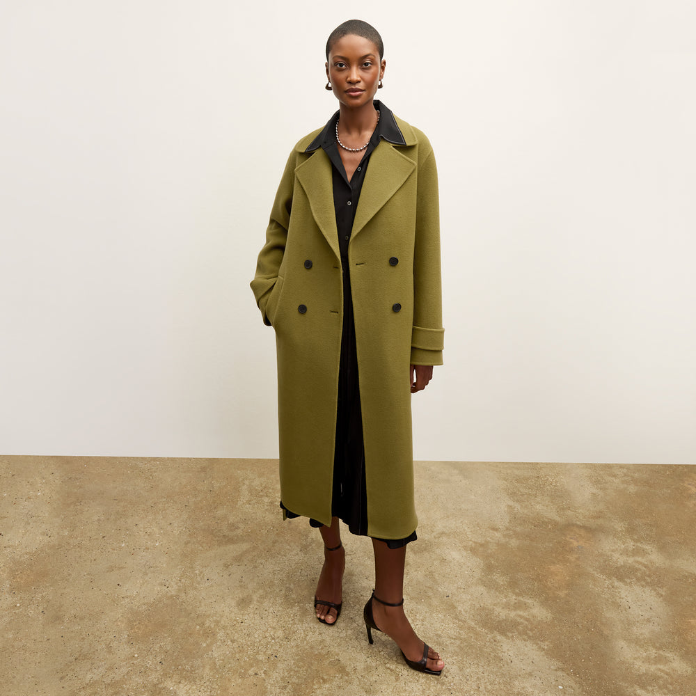 front image of a woman wearing the viola coat in pistachio