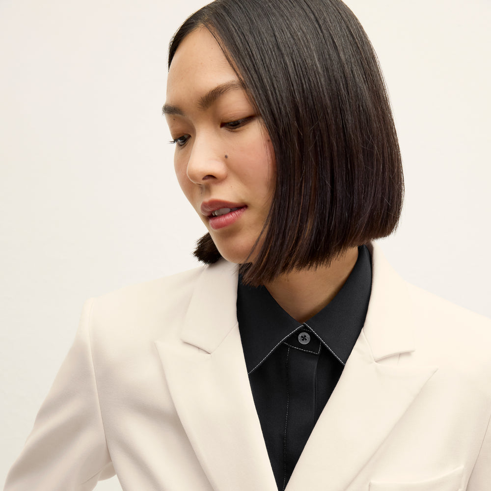 front image of a woman wearing the kati jacket in ivory