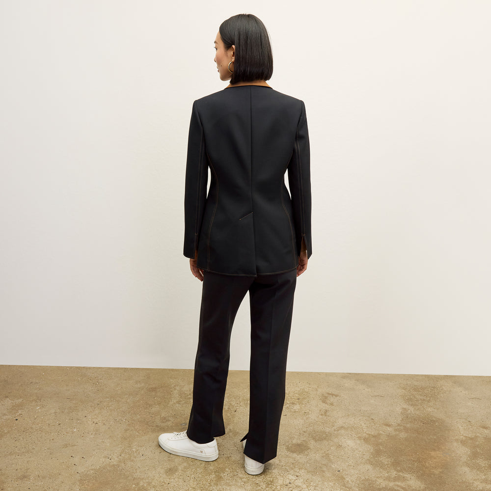 back image of a woman wearing the sella pant in black/light saddle