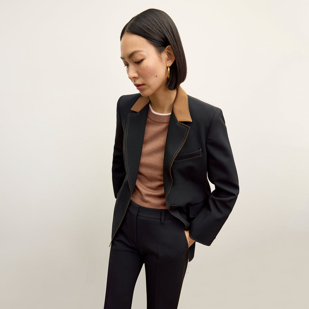 front image of a woman wearing the kit sweater in camel/ivory
