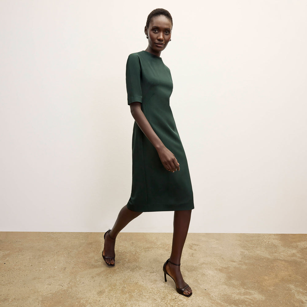 front image of a woman wearing the farnoosh dress in emerald
