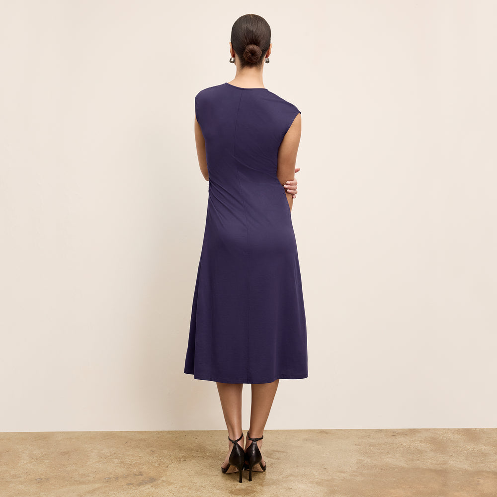 back image of a woman wearing the marina dress in deep iris