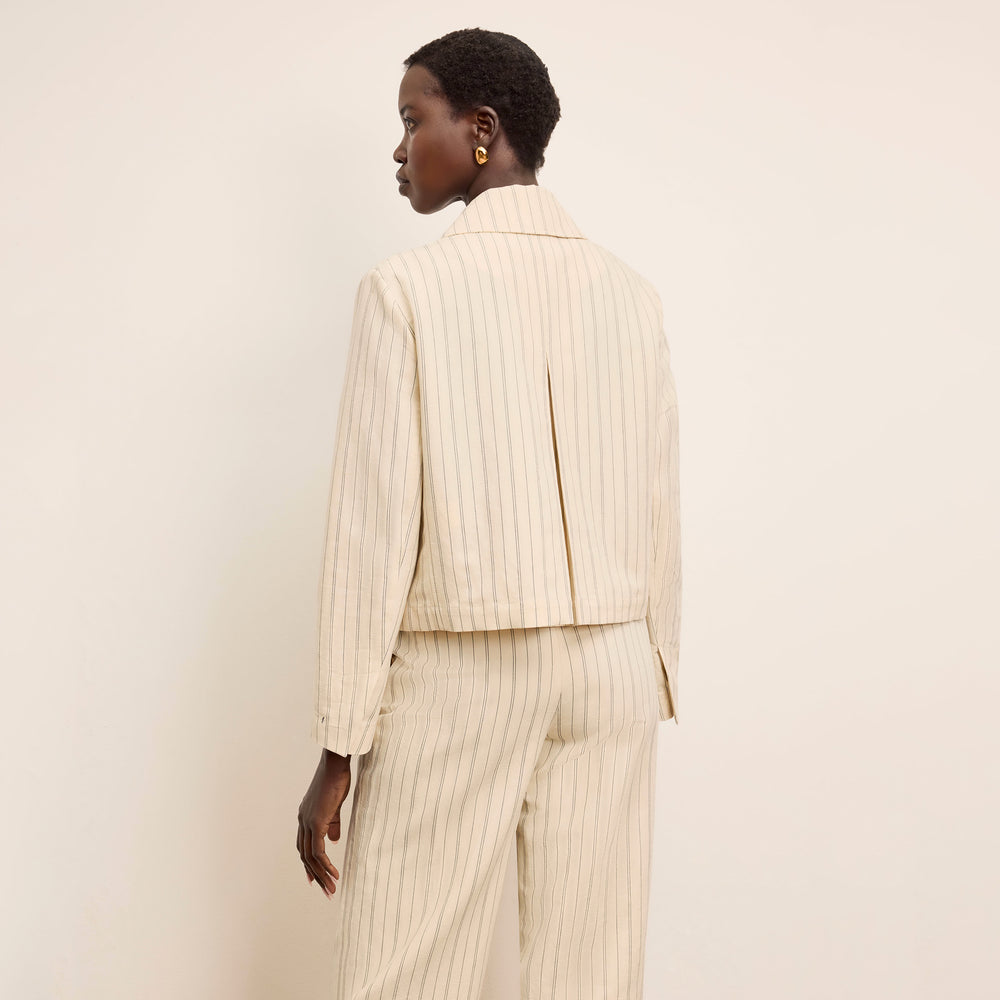 back image of a woman wearing the nicky jacket in linen stripe