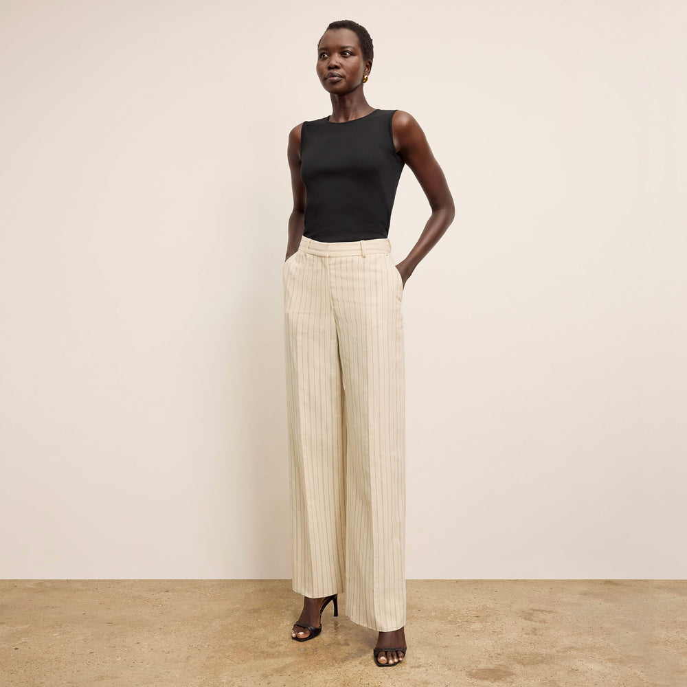 Front image of a woman standing wearing the paige top in fine ribbed cotton in black