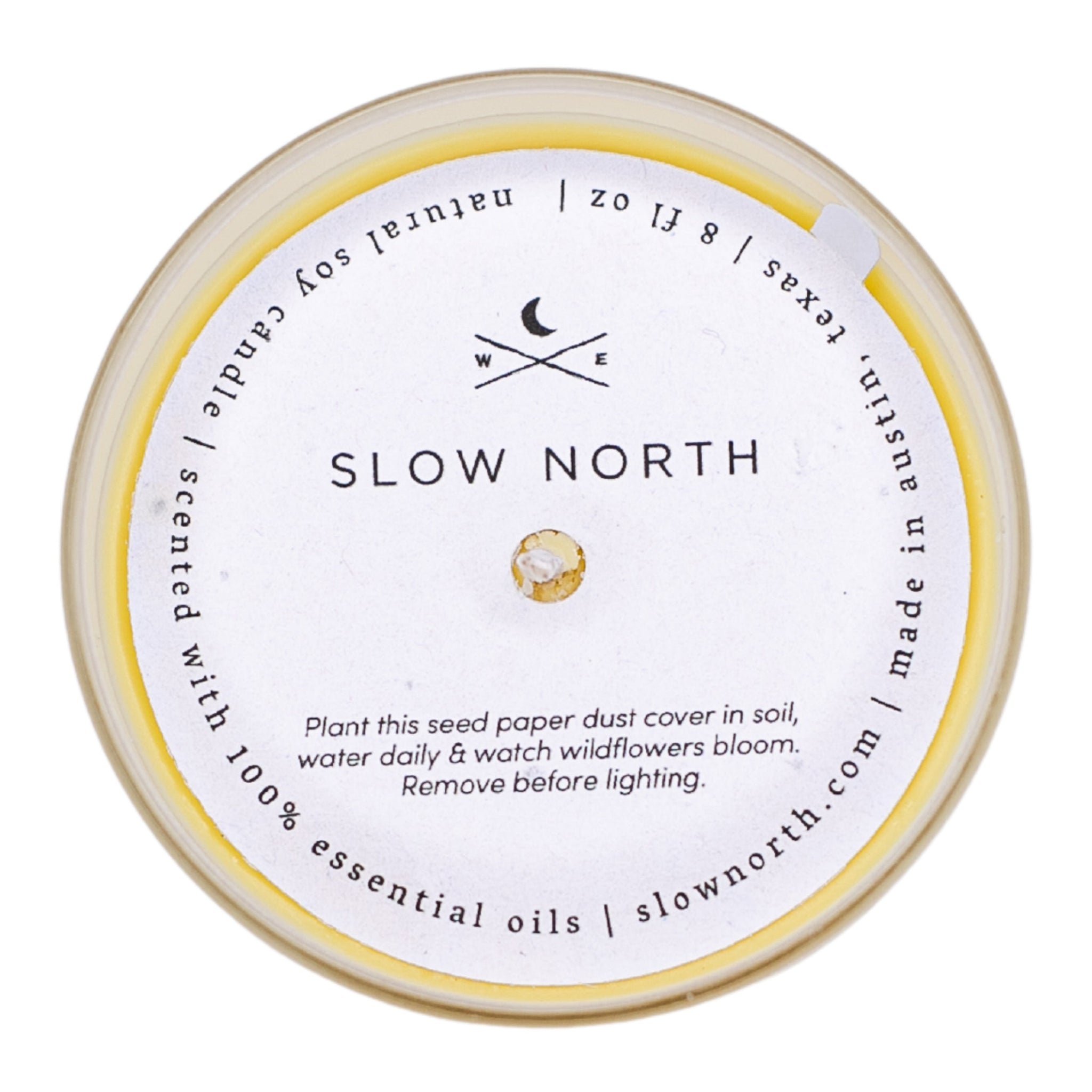 Round candle with 'Slow North' branding on a white background