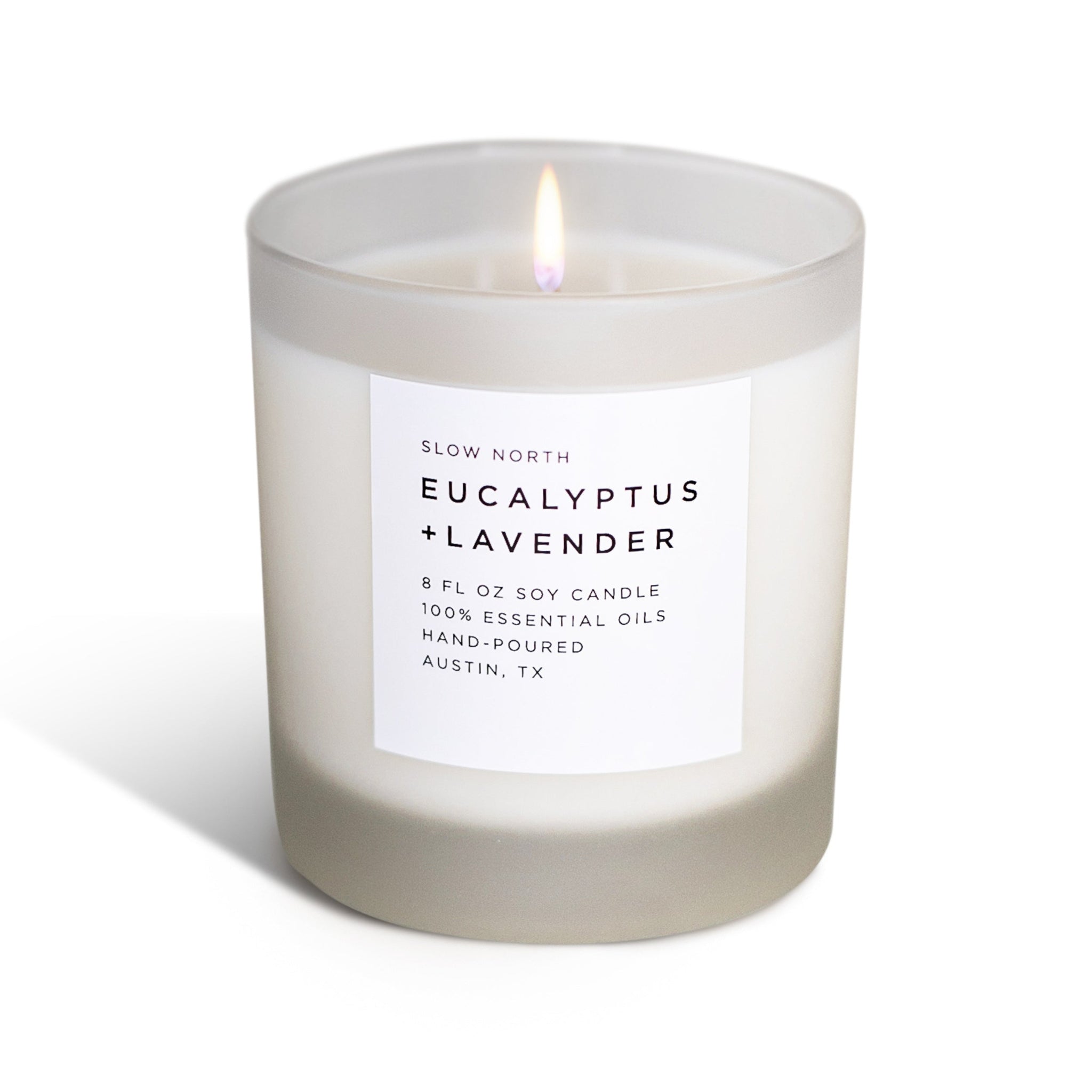 Candle with a label reading 'Eucalyptus + Lavender' on a white background 