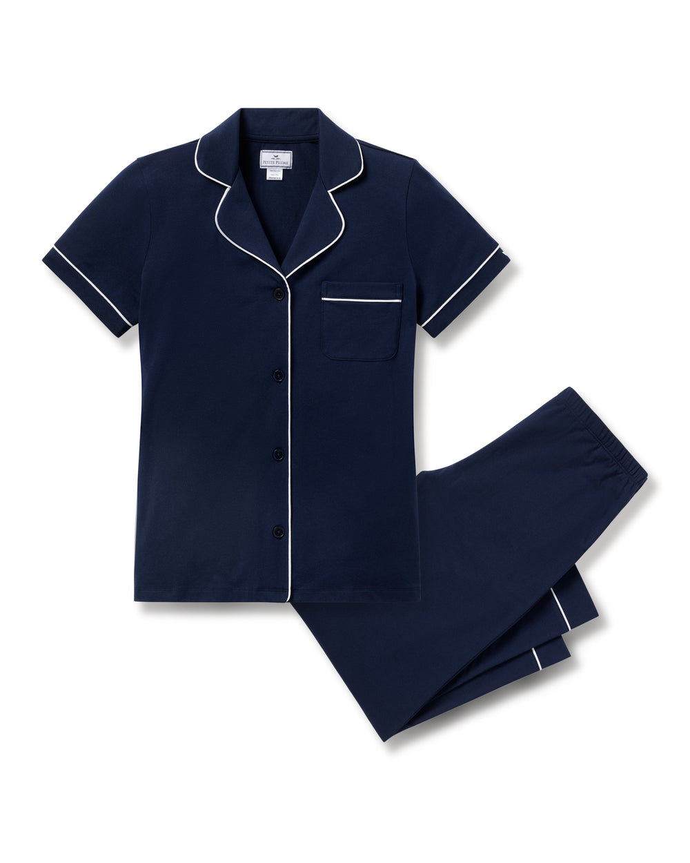 Navy blue pajama set with white piping on a white background