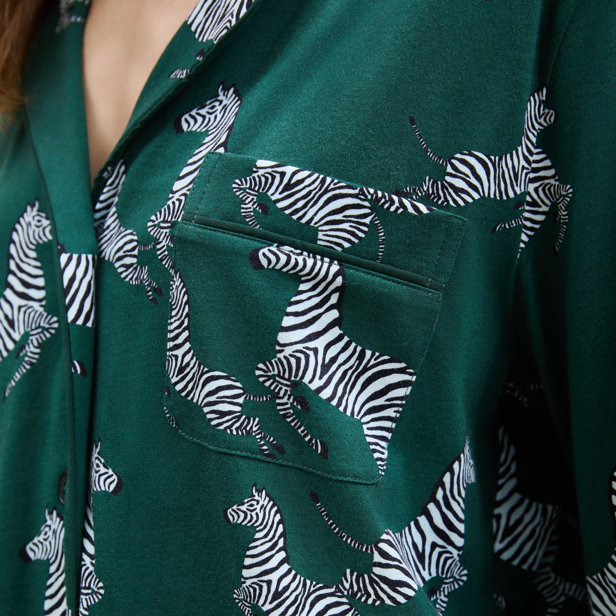 Green shirt with zebra pattern on a dark background