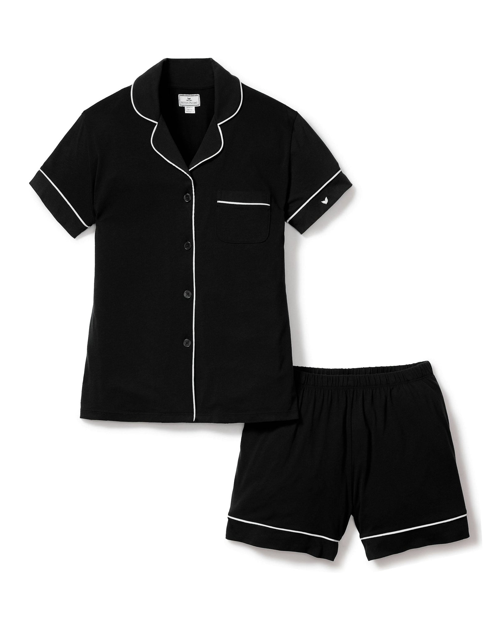 Black pajama set with white piping on a white background
