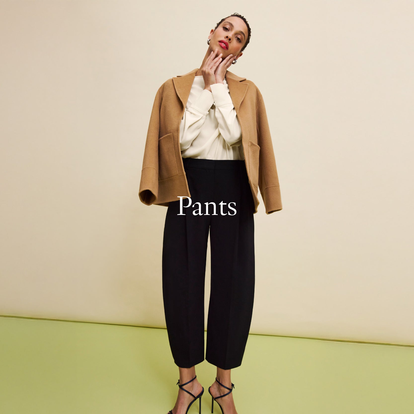 Woman wearing a brown coat and black pants with 'Pants' text overlay on a beige background
